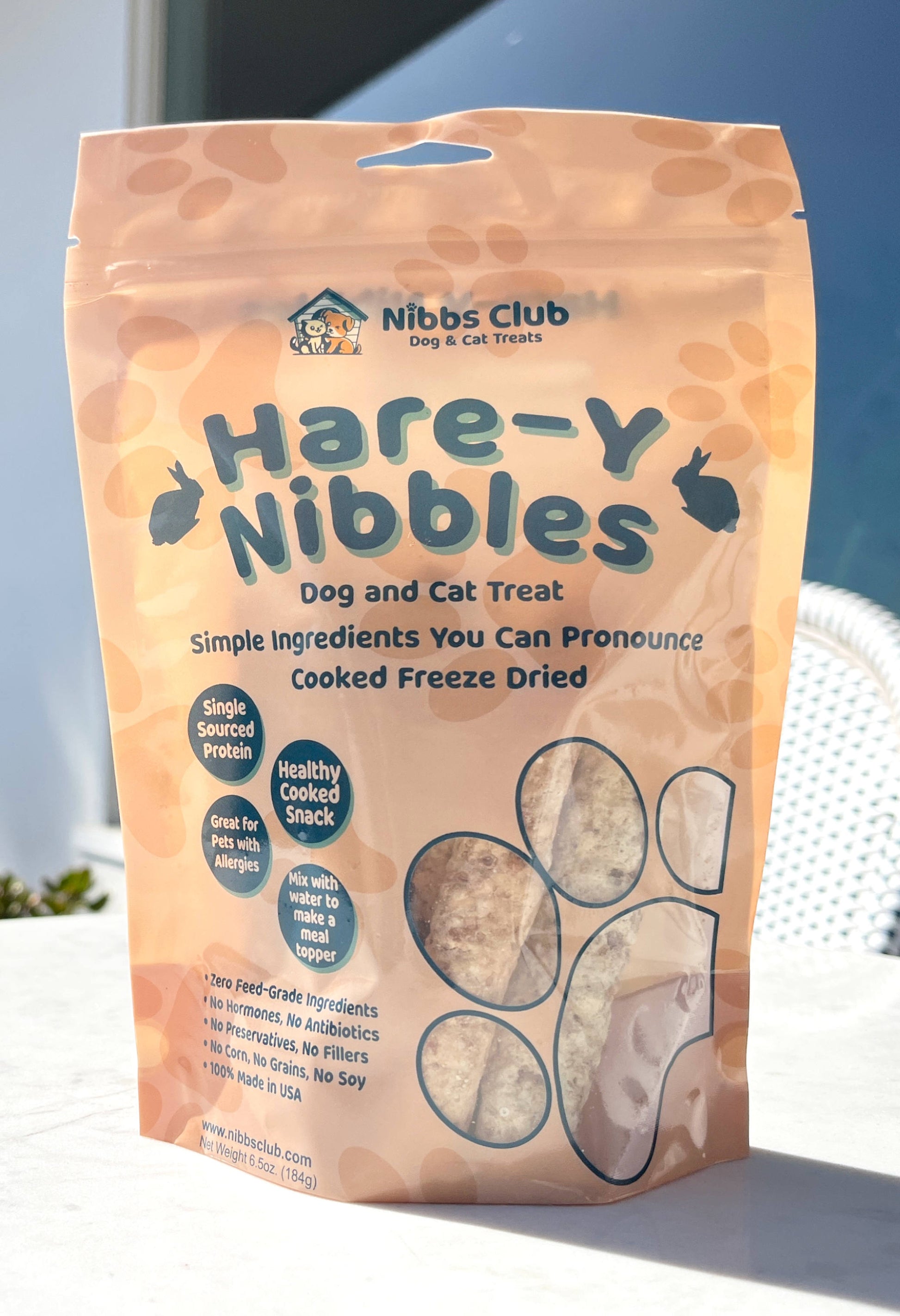 Hare-Y Nibbles Dog and Cat Treats pictured outside on a table